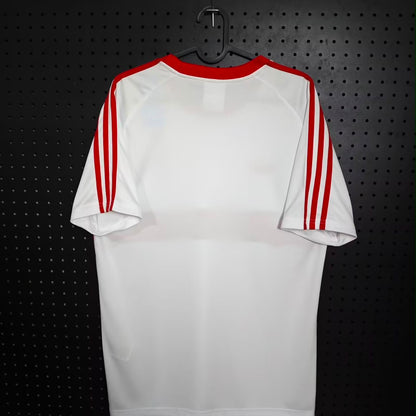 Camisola pré jogo/viagem vermelha/branca 2026/27